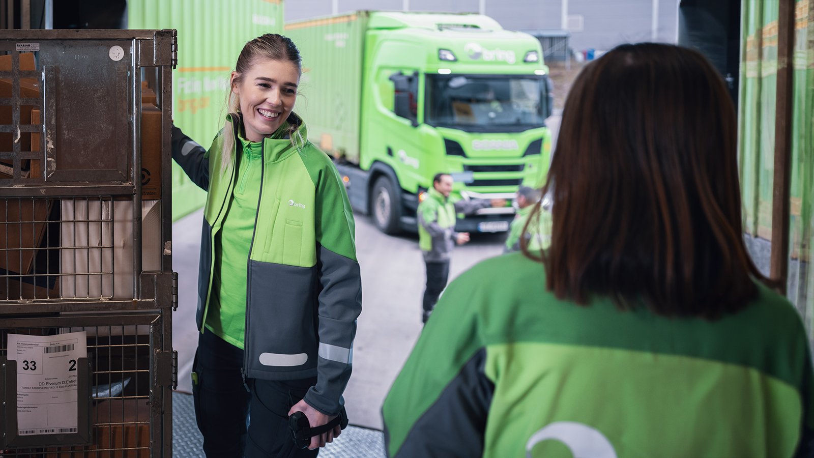 Two female work colleagues talking while working at the Bring terminal.
